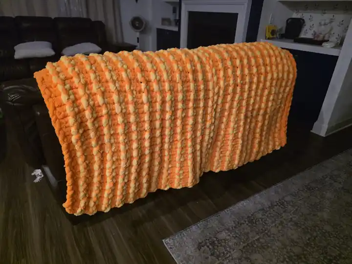 Customer-made chunky knit blanket in orange and cream stripes