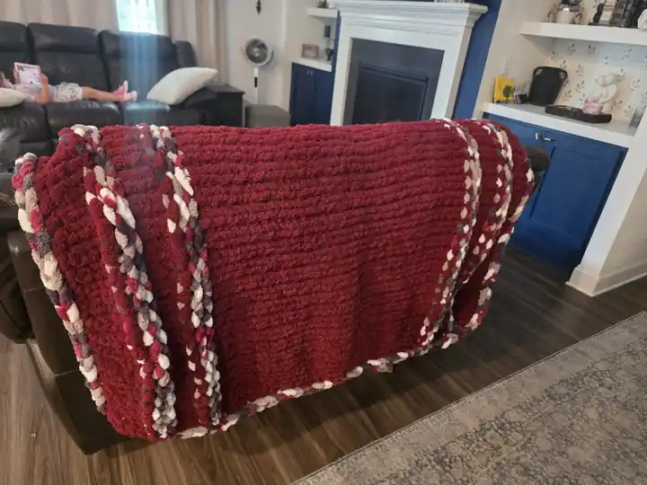 Customer-made burgundy chunky knit blanket with cream trim