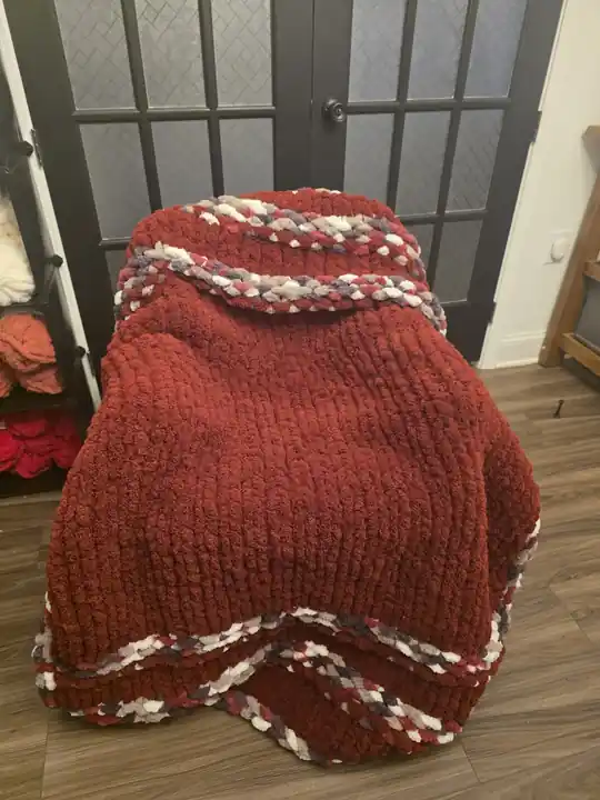 Customer-made deep red chunky knit blanket with a cream and burgundy border