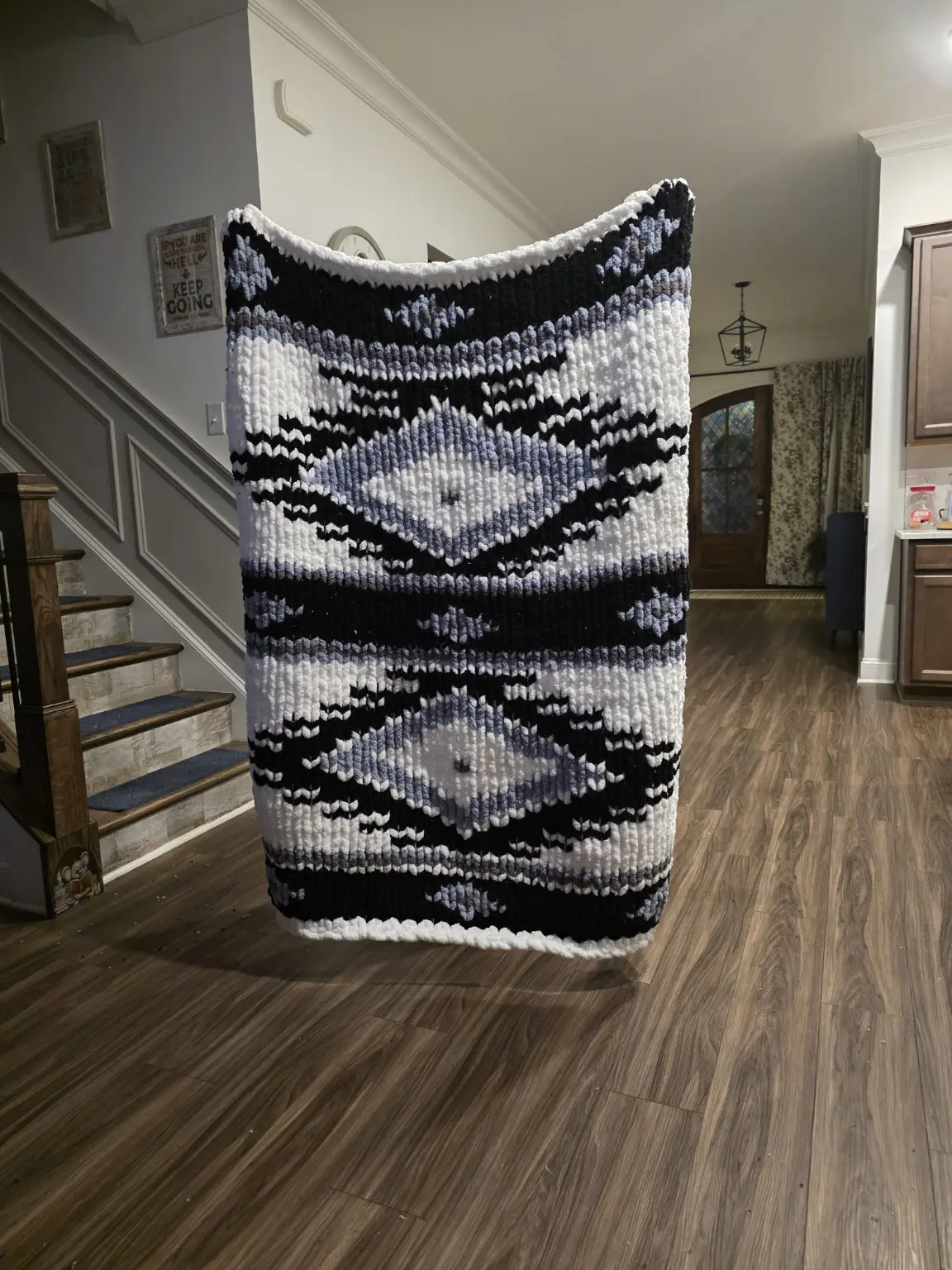 Customer-completed Desert Eye chunky-knit blanket in cream, black and blue-gray with layered diamond motifs