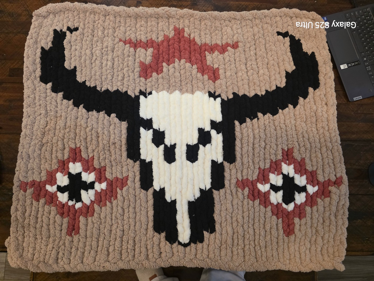 Customer-finished Western Star chunky-knit blanket with a longhorn skull, dusty rose star and diamonds on a tan background